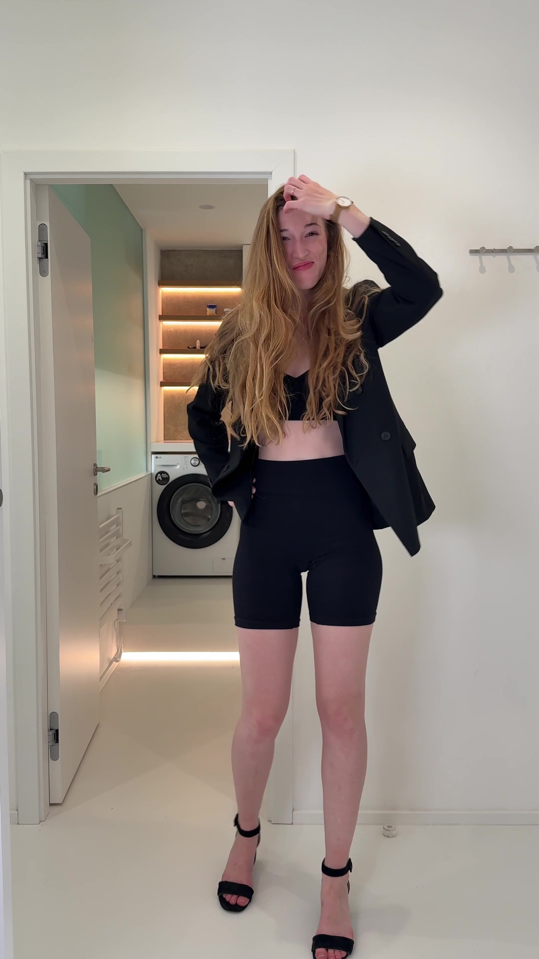 Confident Woman Posing and Styling Hair