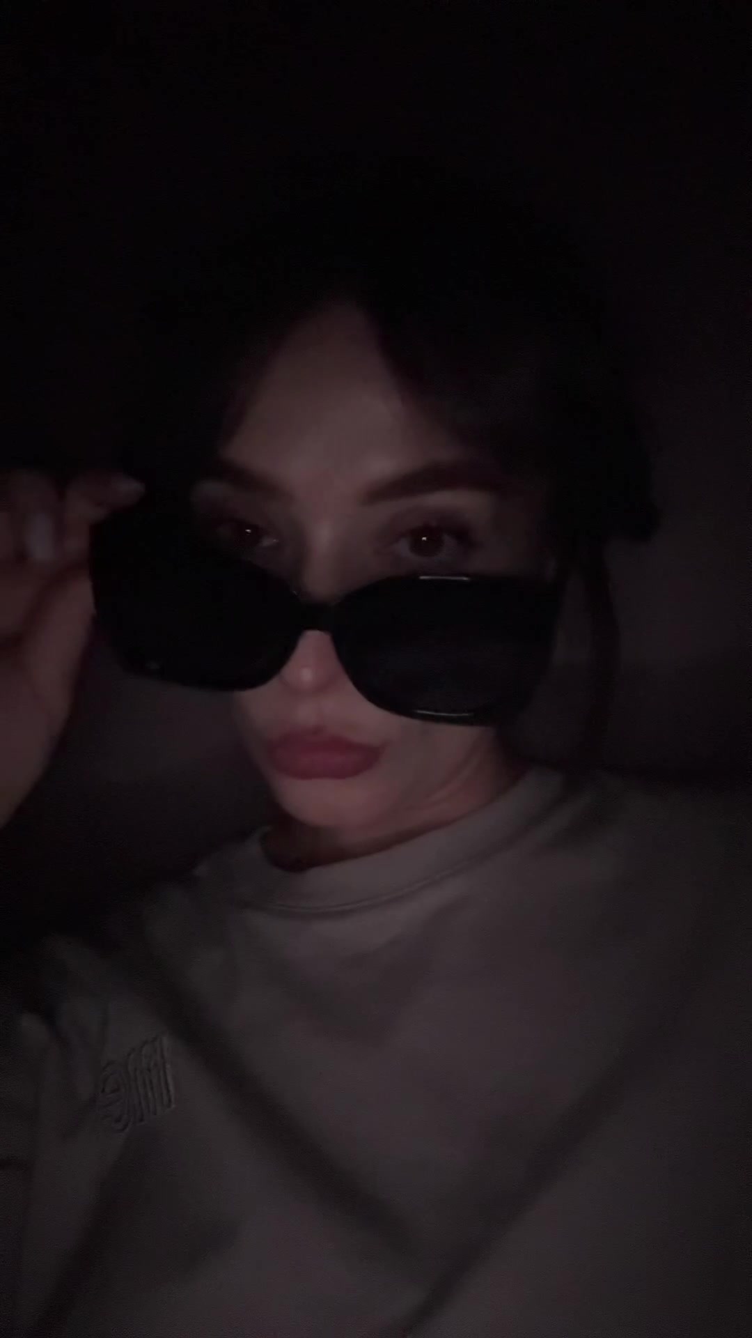 Playful Glance Over Sunglasses
