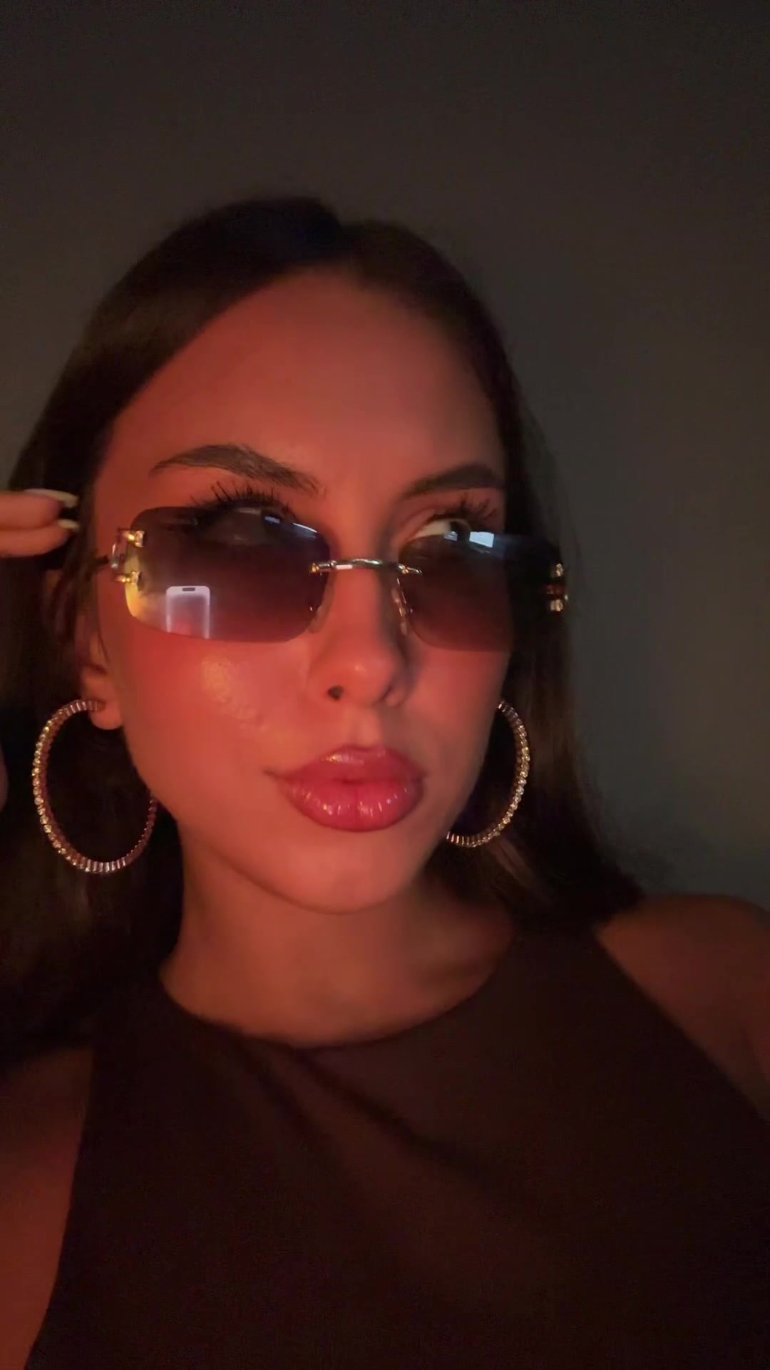 Confident Woman Winks, Adjusts Sunglasses