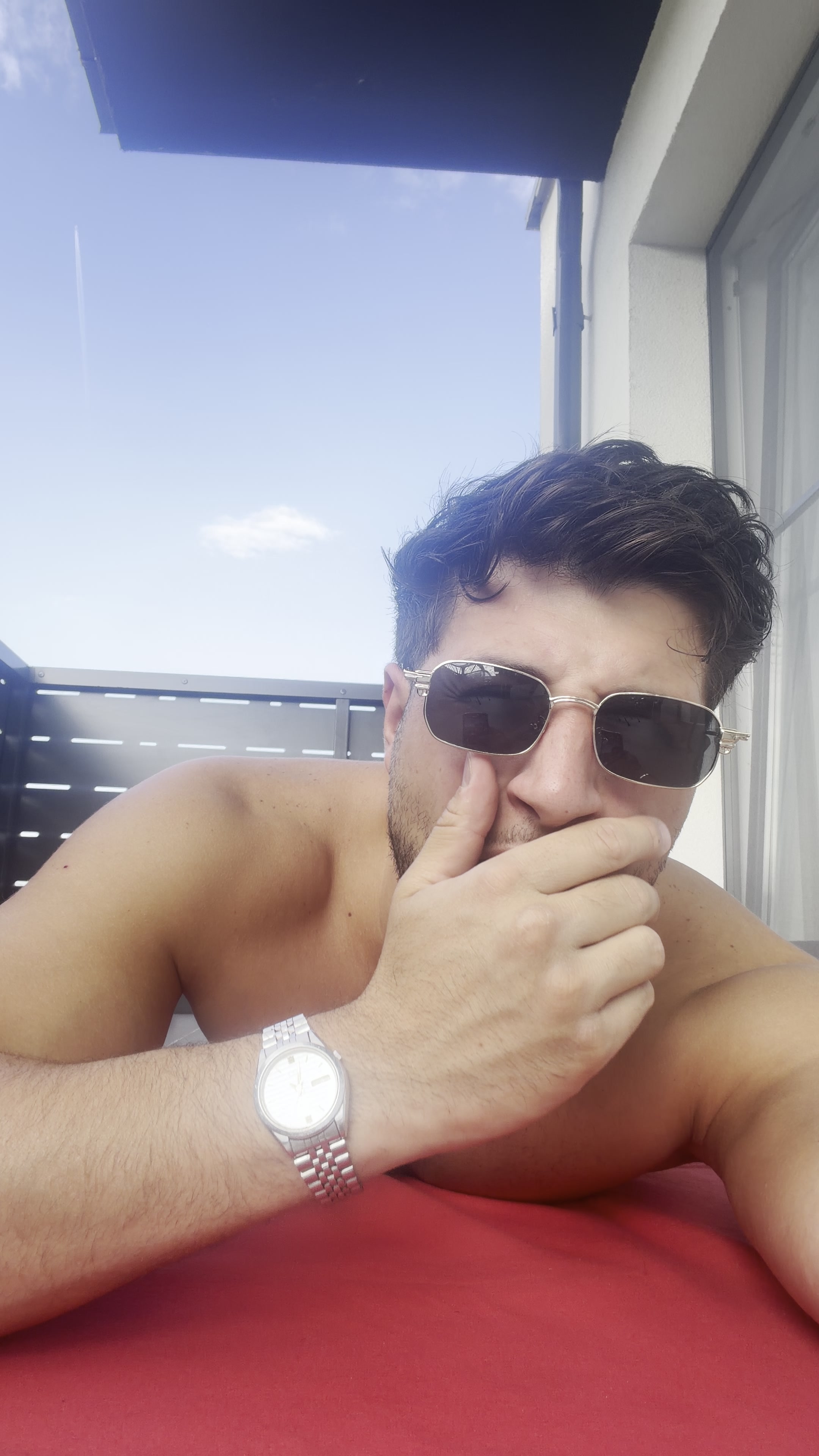 Confident Man Relaxing on Balcony