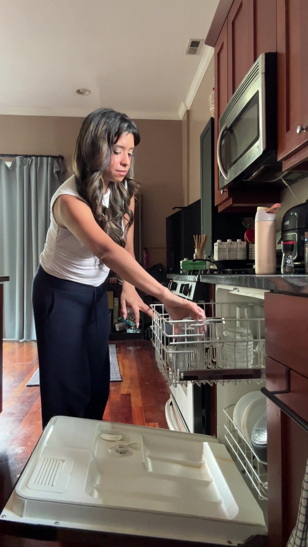 Woman Unloading Clean Dishes from Dishwasher