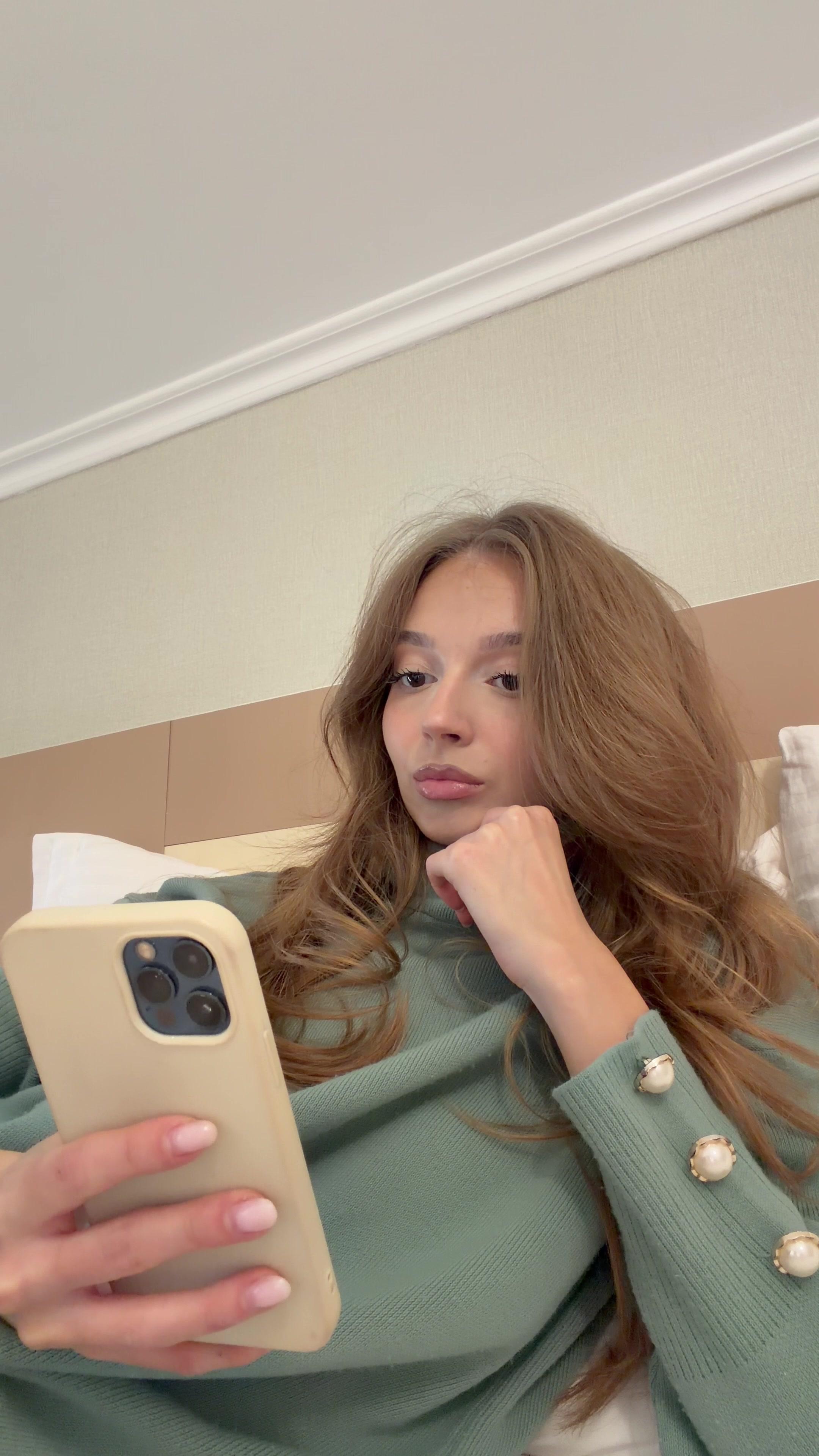 Shocked Woman Looking at Phone in Bed