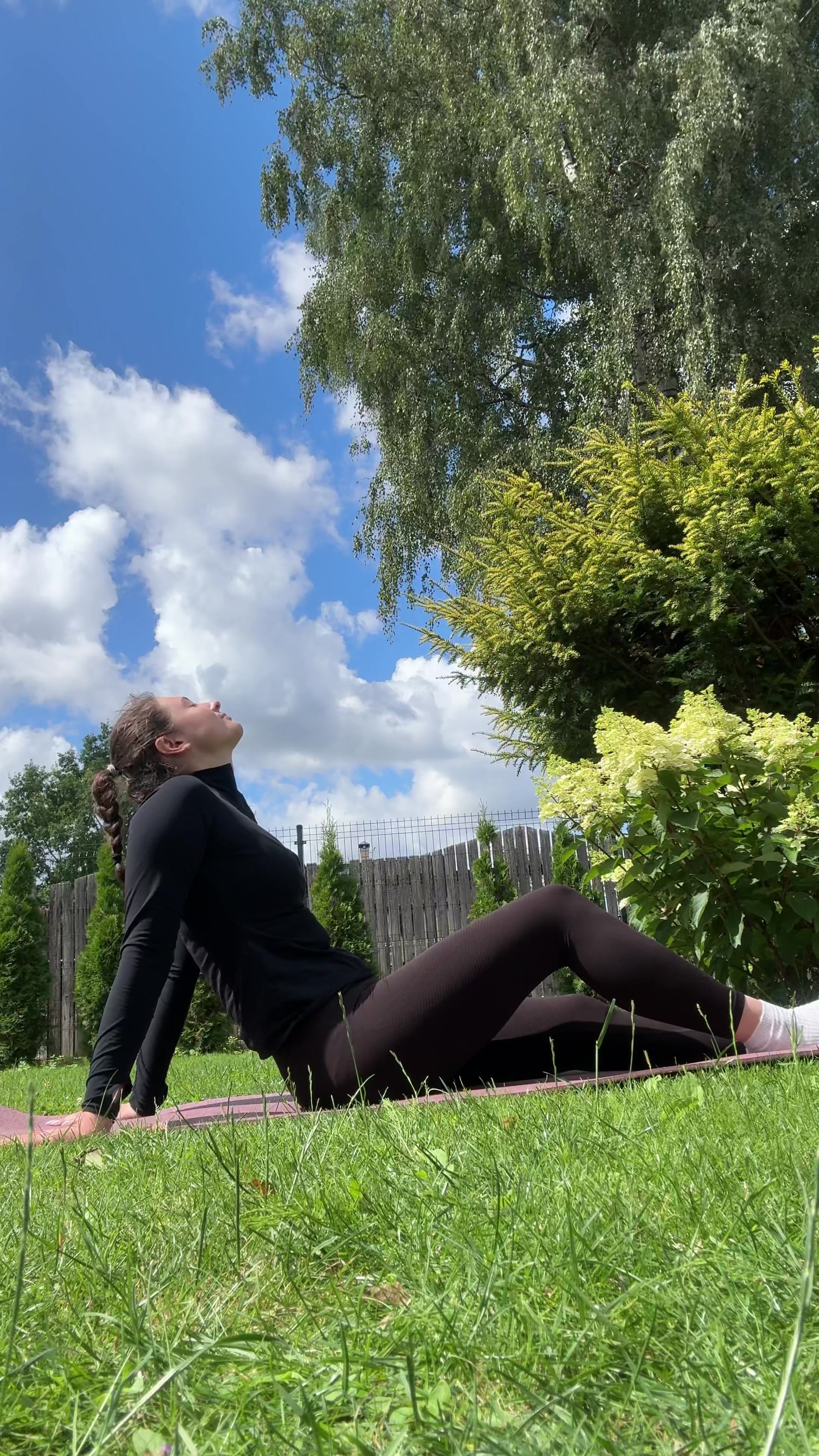 Woman Stretches on Mat Outdoors