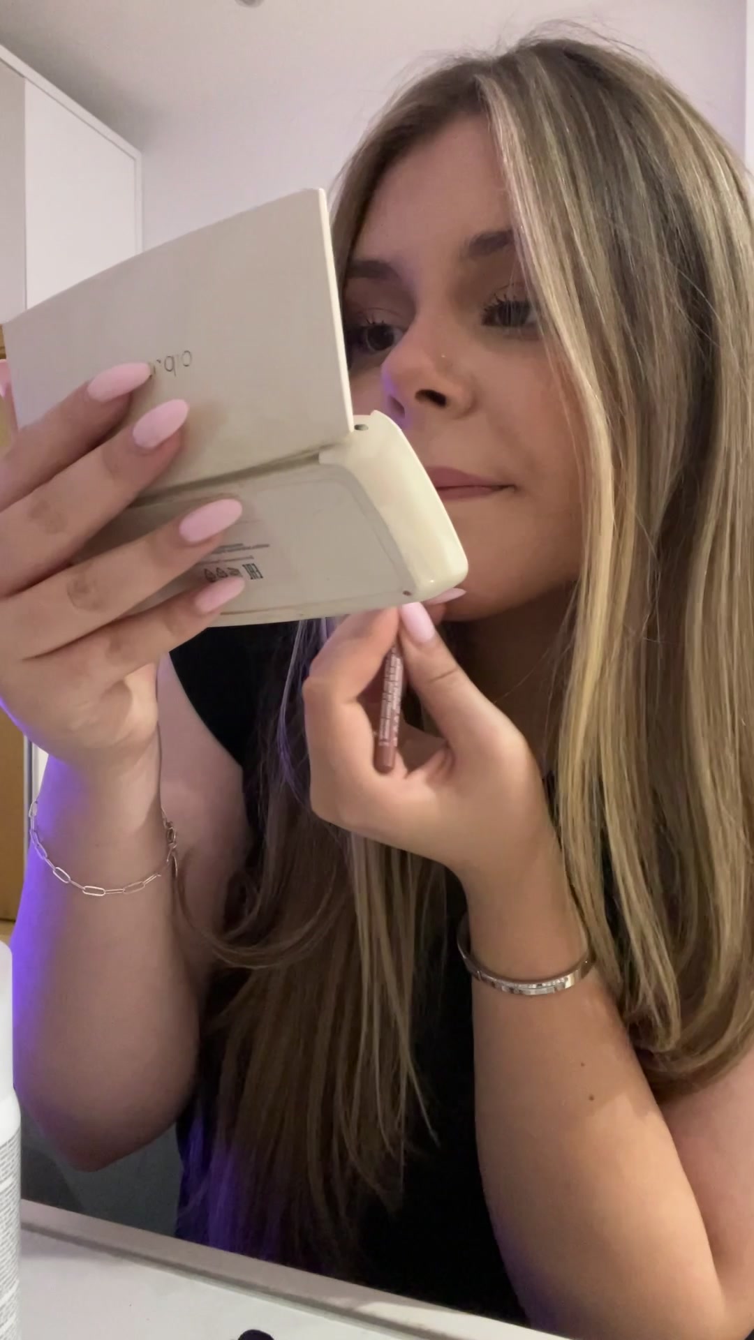 Woman applying lip liner and blush