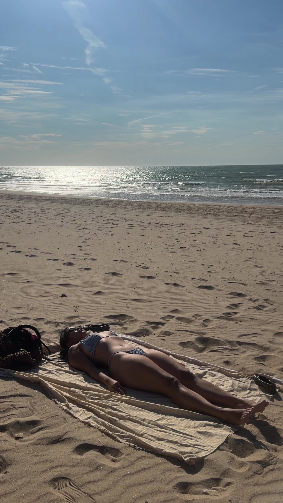 Woman Sunbathing on a Sunny Beach